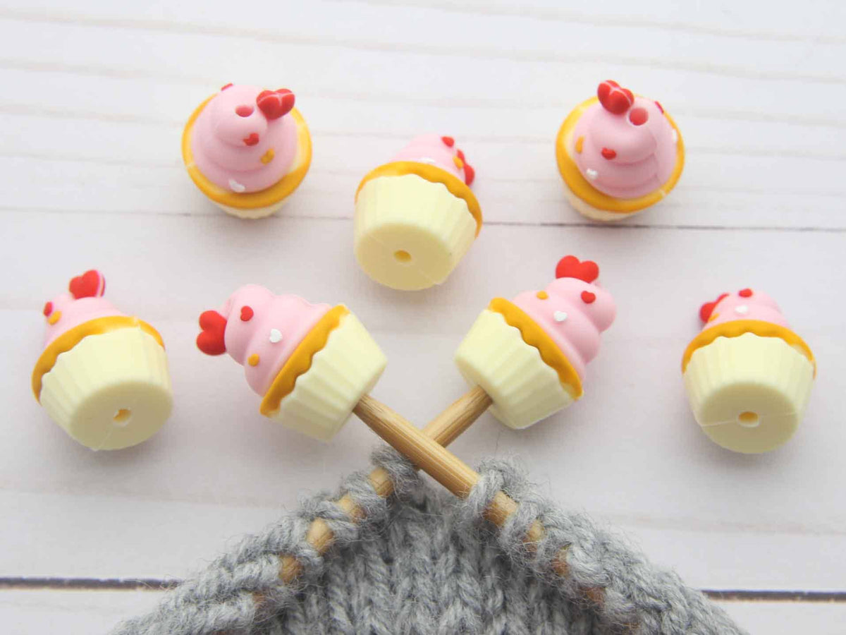 Sets of cupcake stitch stoppers on knitting needles