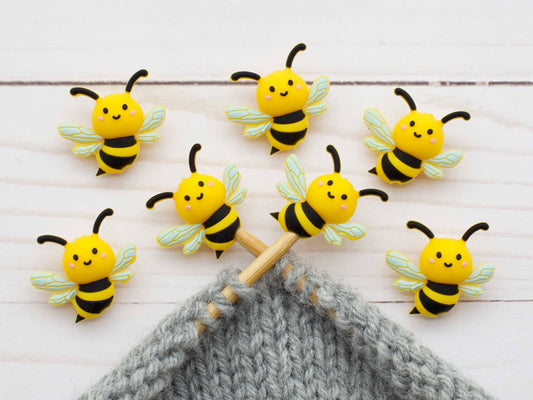 Bee stitch stoppers on knitting needles