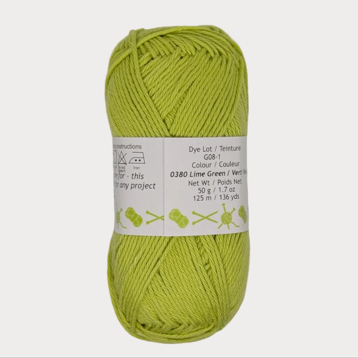 Green skein of yarn with a label on a light gray background