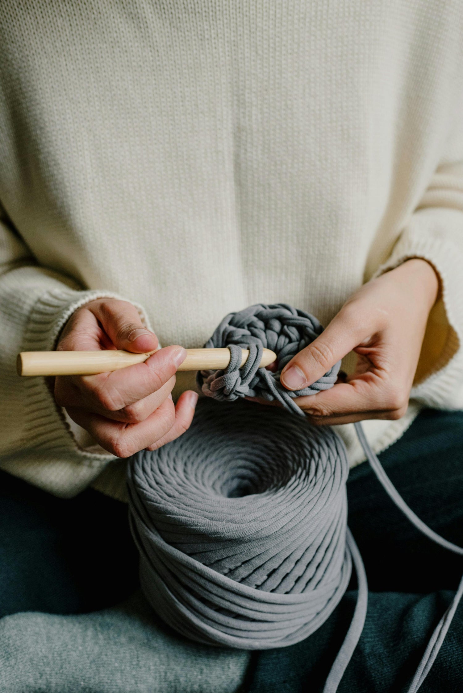 Woman Crocheting with a Wooden Hook