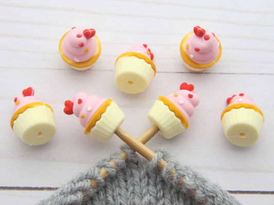 Sets of cupcake stitch stoppers on knitting needles