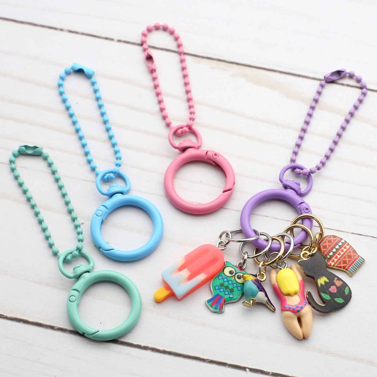 Colorful keychains with charms on a wooden surface