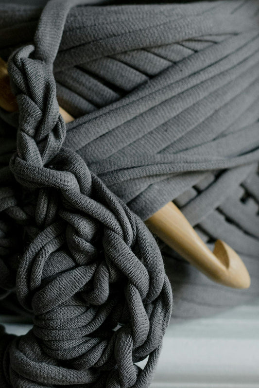 Close-up of gray shoelaces with a wooden lace hook on a blurred background