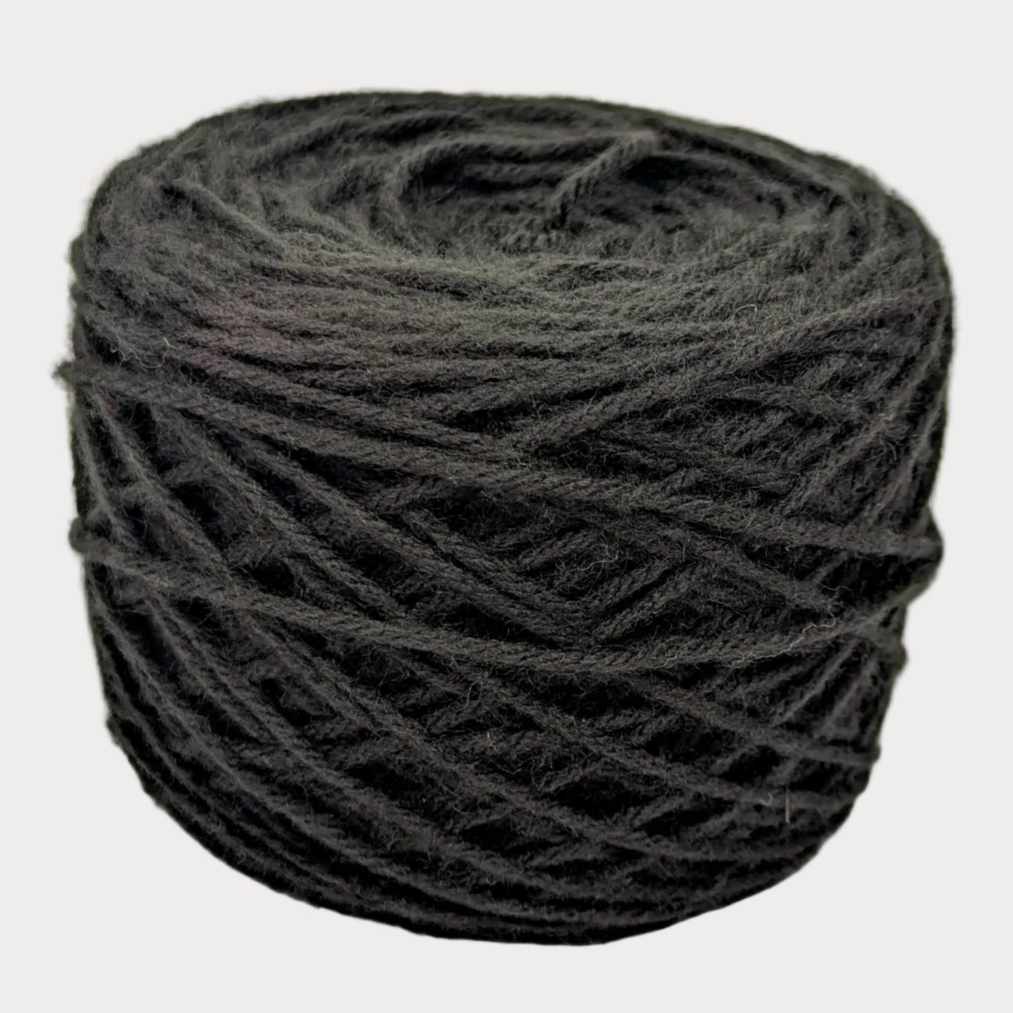 Ball of dark gray yarn on a white background