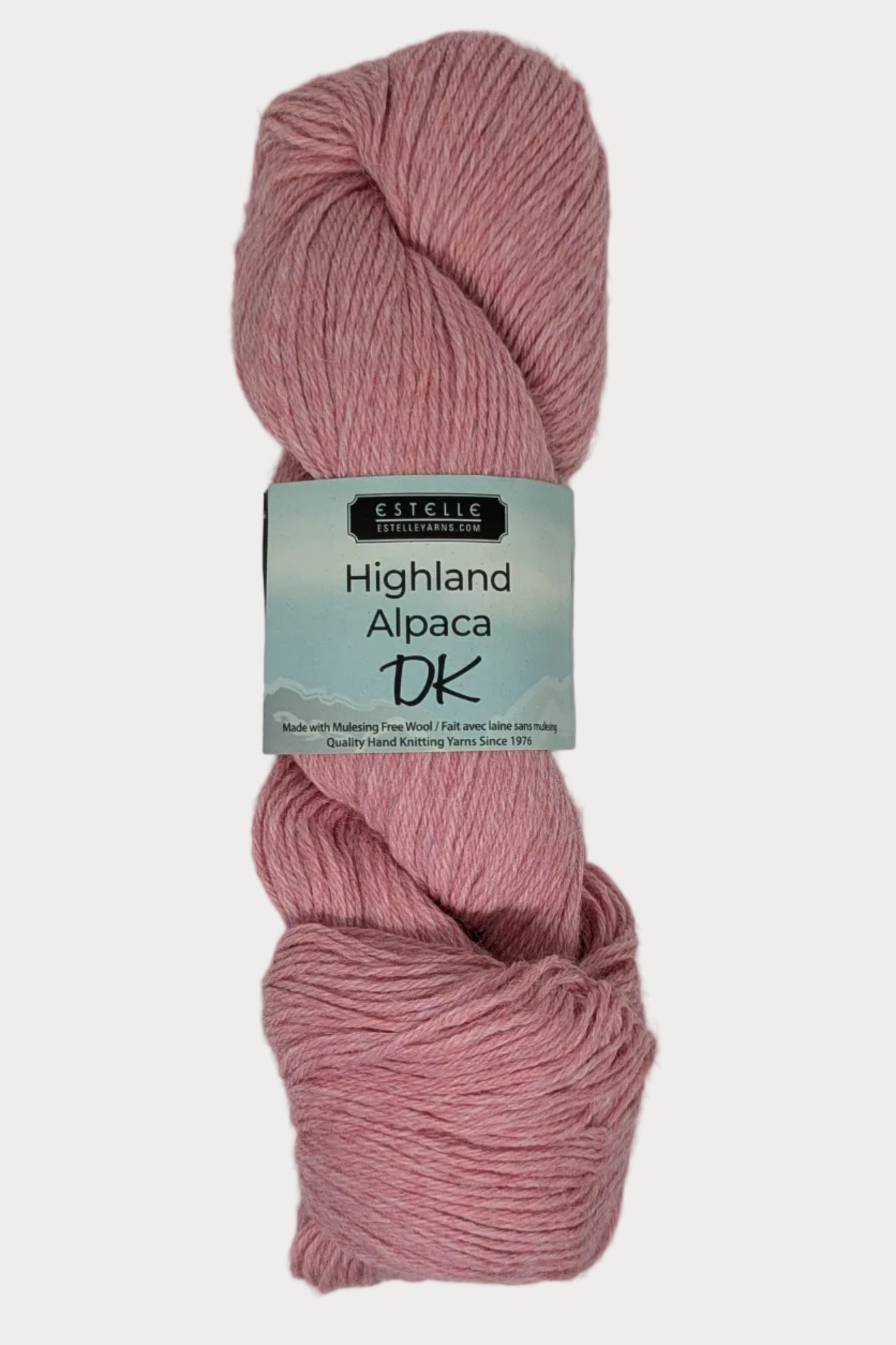 Ball of pink yarn with a label on a white background