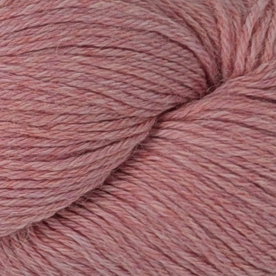 Ball of pink yarn with a label on a white background