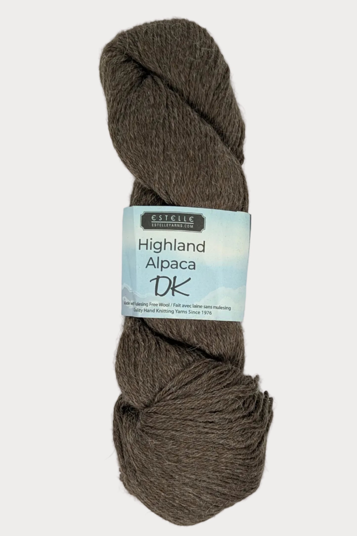 Brown skein of yarn with a label on a white background