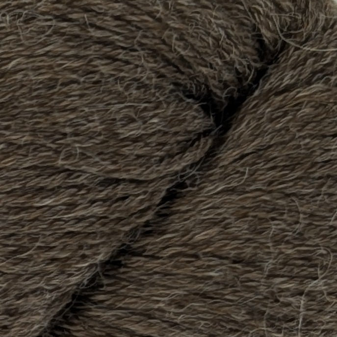 Brown skein of yarn with a label on a white background