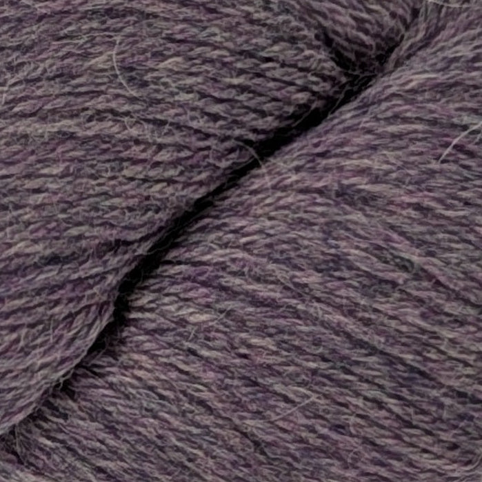 Purple skein of yarn with a label on a white background