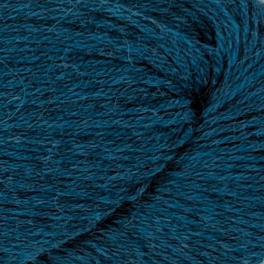 Blue skein of yarn with a label on a white background