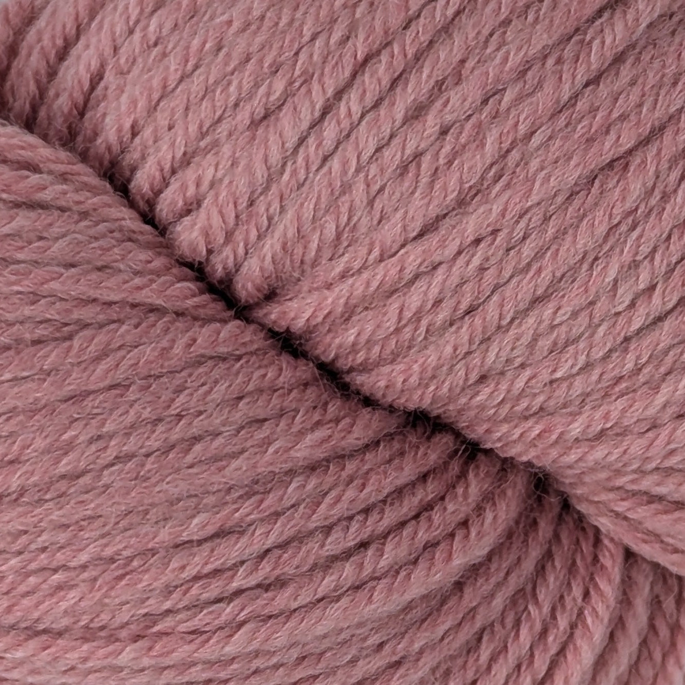 Pink skein of yarn on a white background