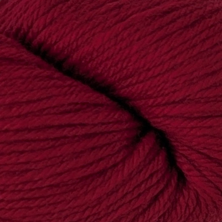 Red skein of yarn on a white surface