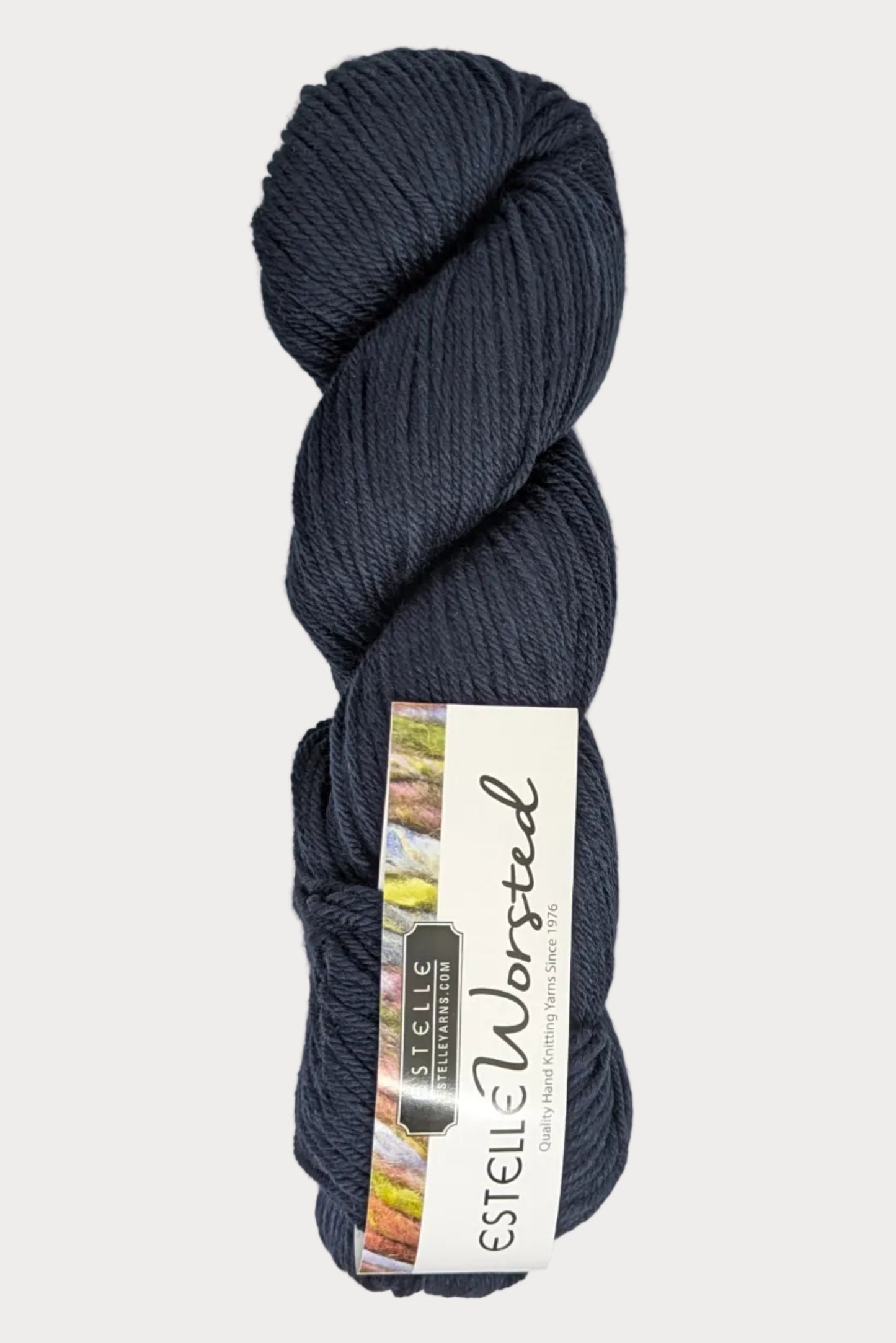 Dark blue skein of yarn with a label on a white background