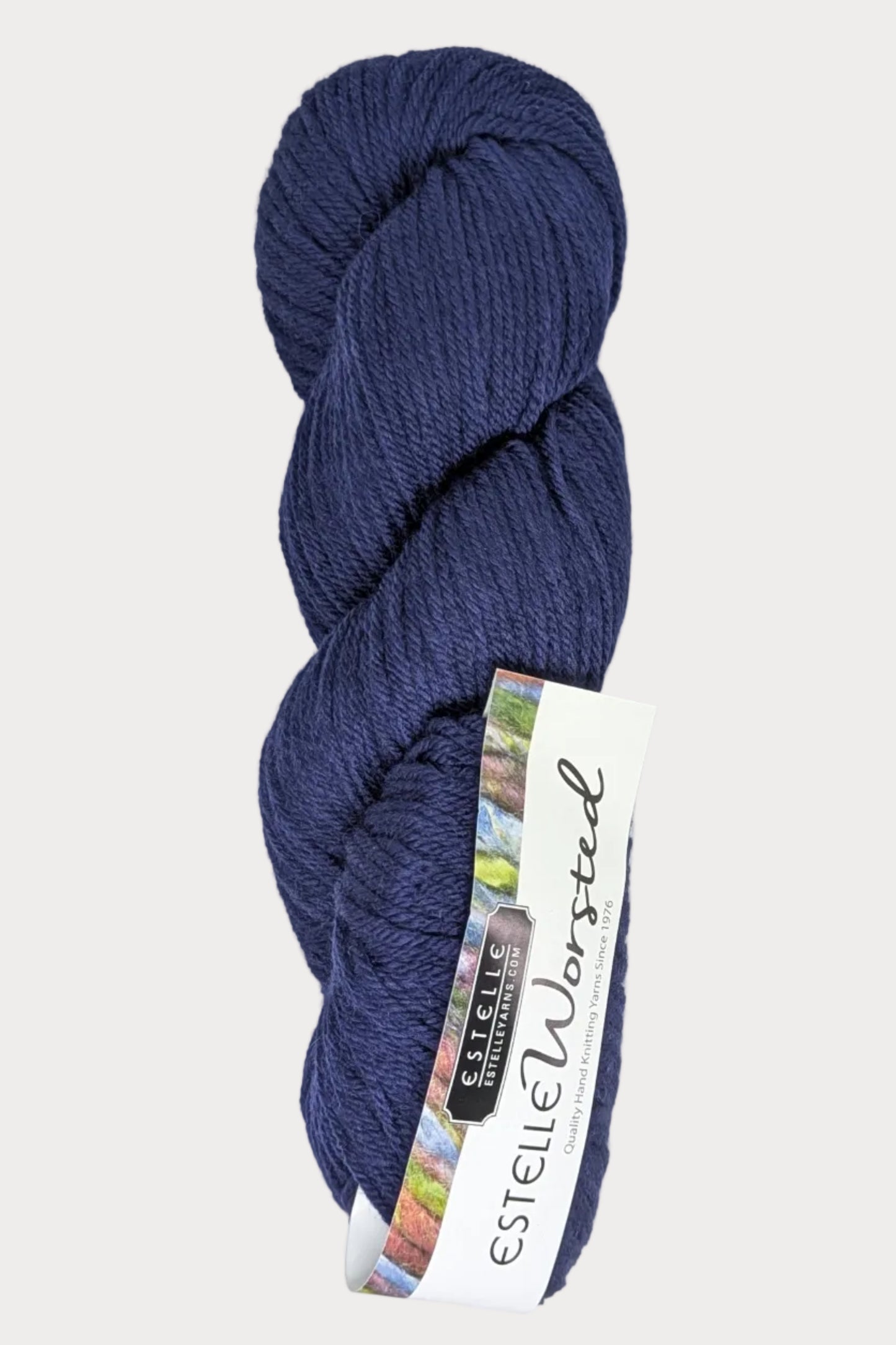 Blue skein of yarn with a label on a white background