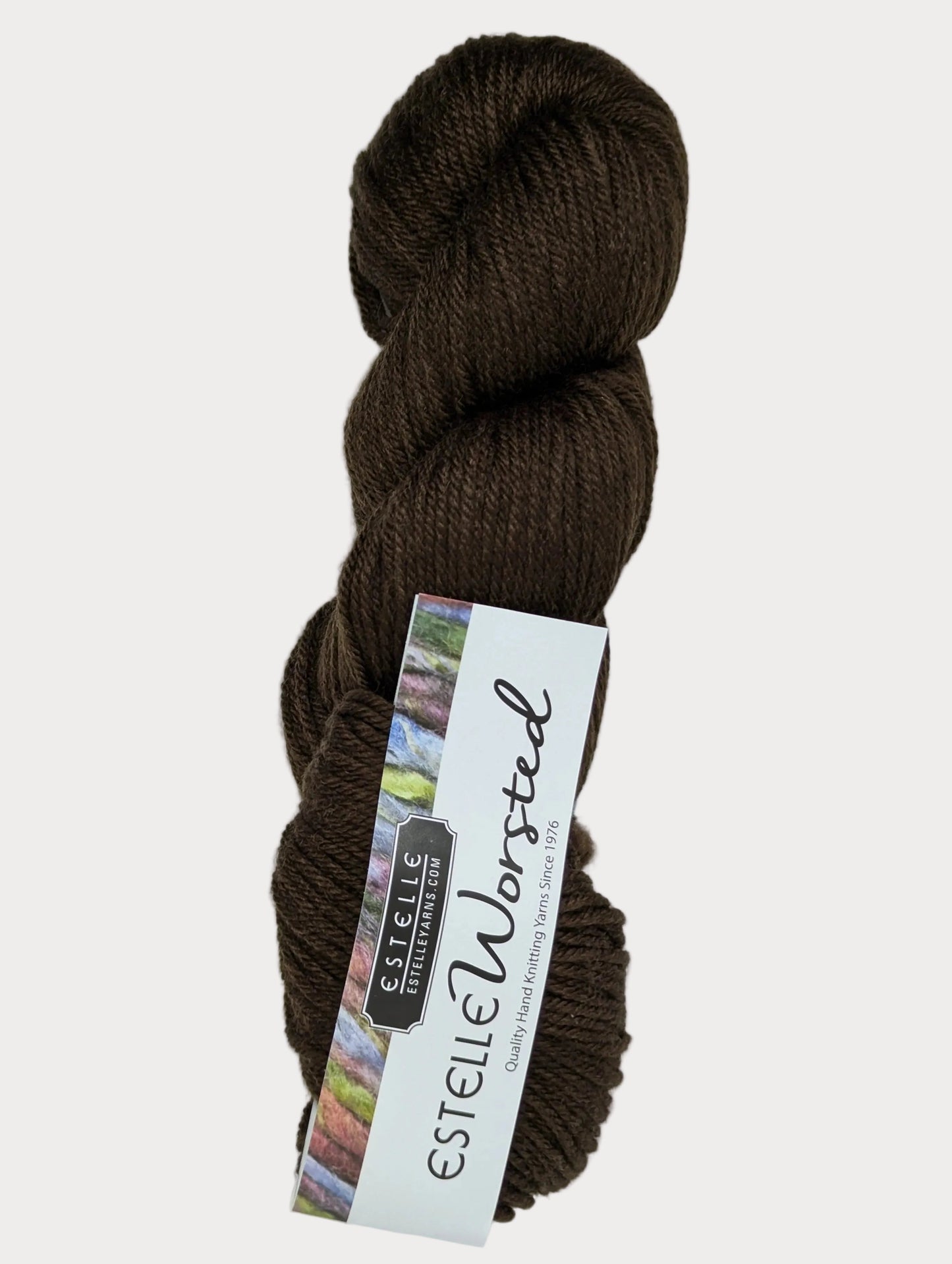 Brown skein of yarn with a label on a white background