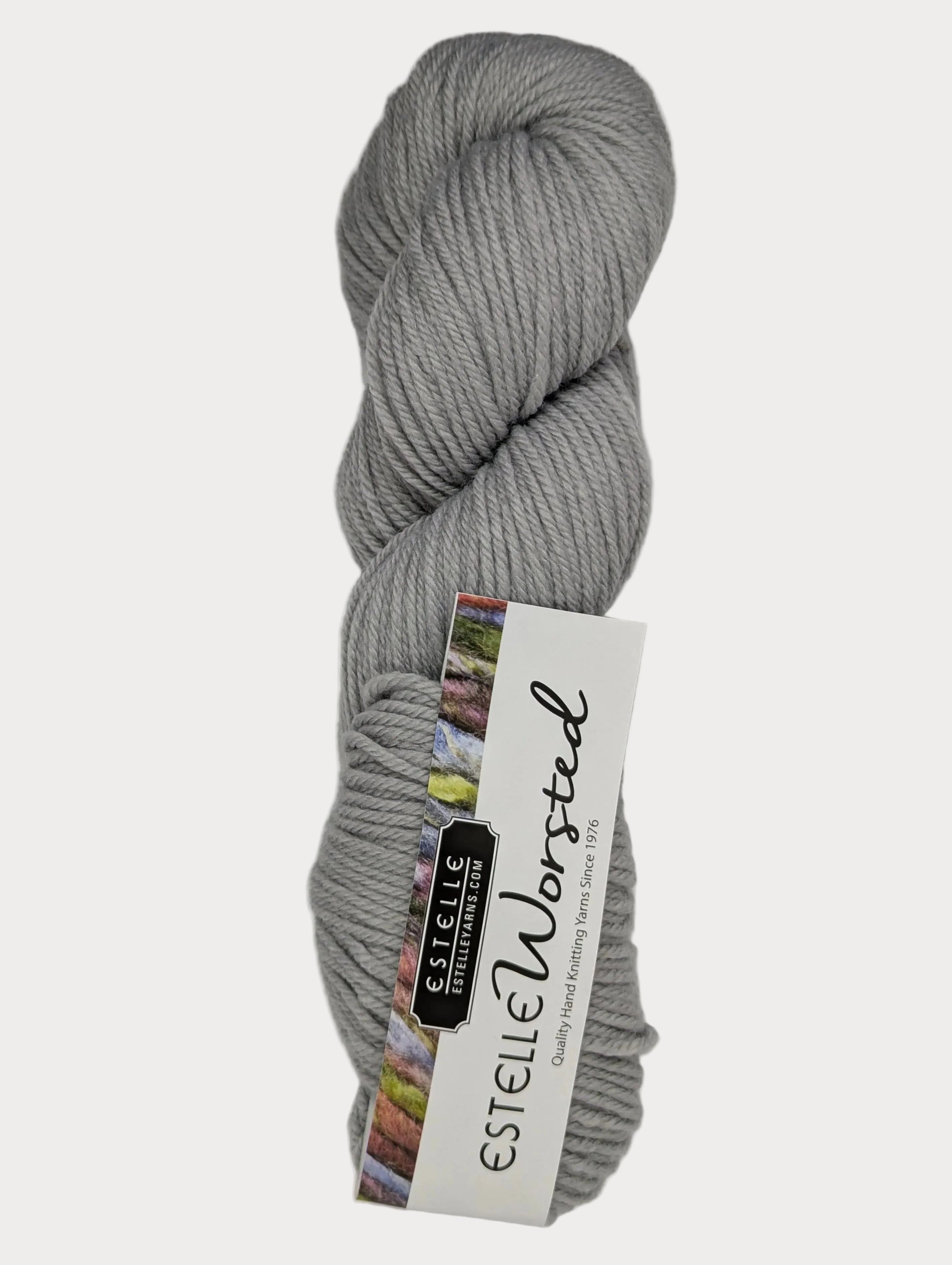 Gray skein of yarn with Estelle Yarns label on a white background