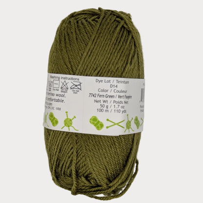 Ball of green yarn with a label on a light gray background