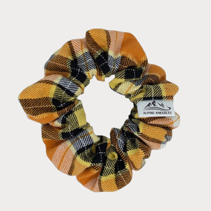 Plaid scrunchie with a brand label on a white background