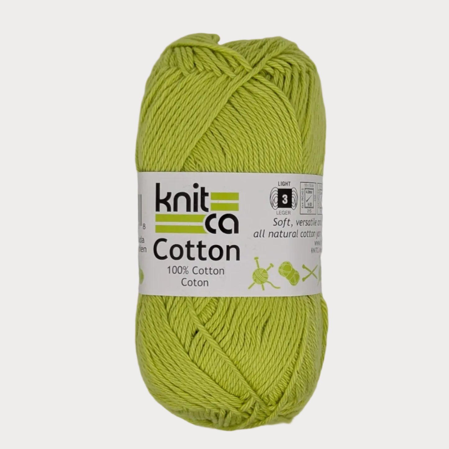 Ball of green yarn with a 'Knitca Cotton' label on a light gray background