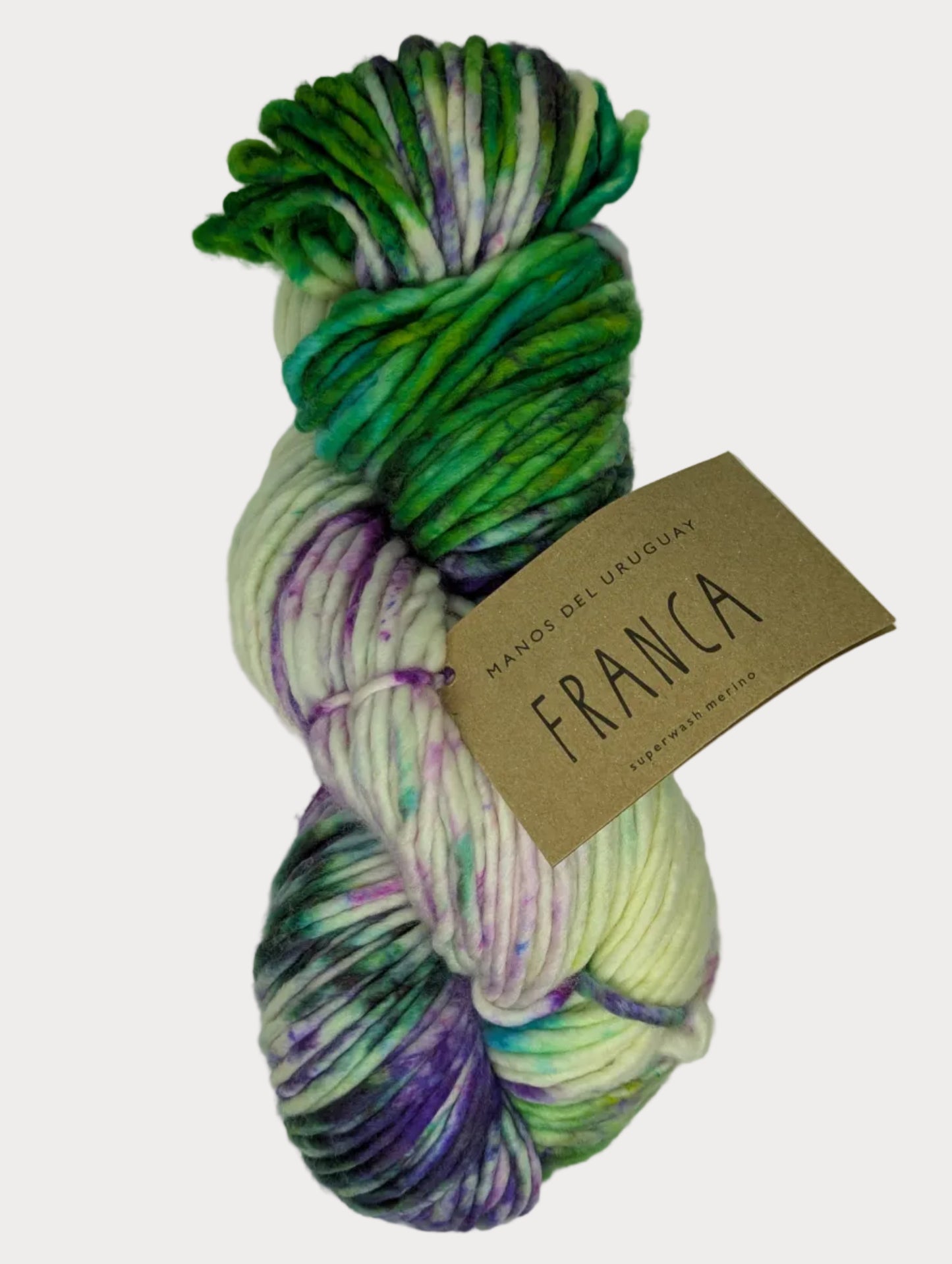 Multicolored skein of yarn with a 'Franca' tag on a light background