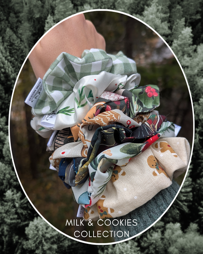 Collection of colorful scrunchies on a wrist with a forest background, labeled 'Milk & Cookies Collection'.