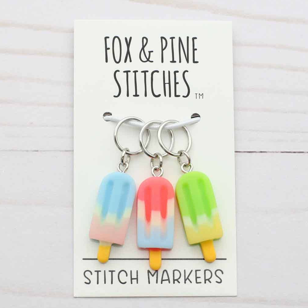 Set of colorful stitch markers on a card with 'Fox & Pine Stitches' branding.