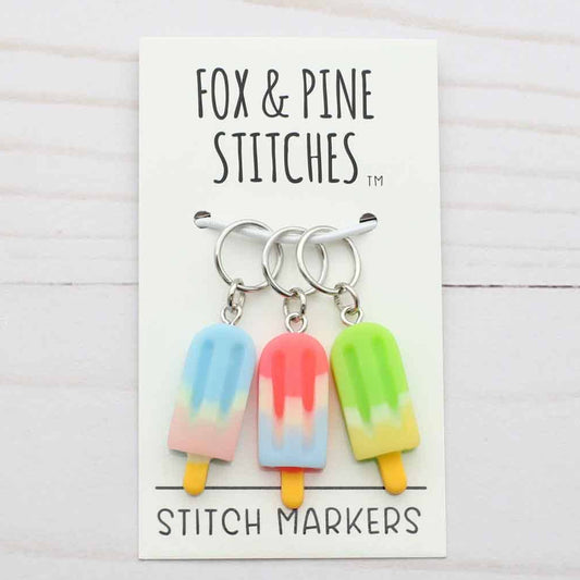 Set of colorful stitch markers on a card with 'Fox & Pine Stitches' branding.