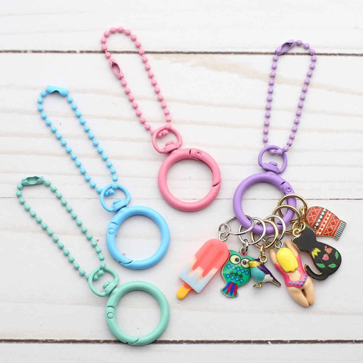 Colorful keychains with charms on a wooden surface