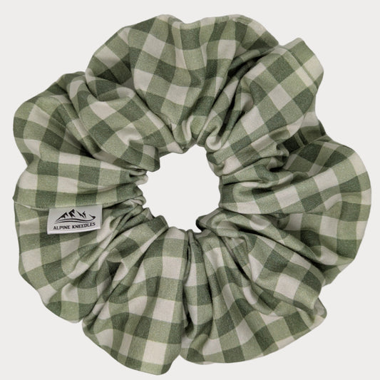 Green and white checkered scrunchie on a gray background