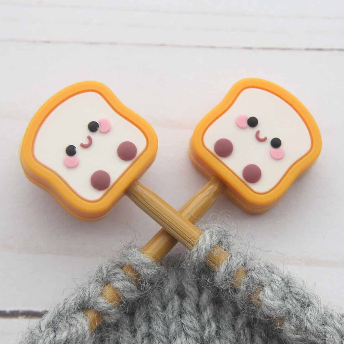 Toast stitch stoppers on knitting needles