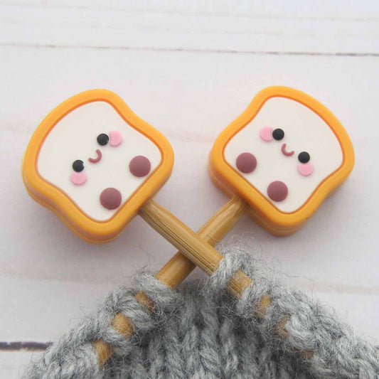 Toast stitch stoppers on knitting needles