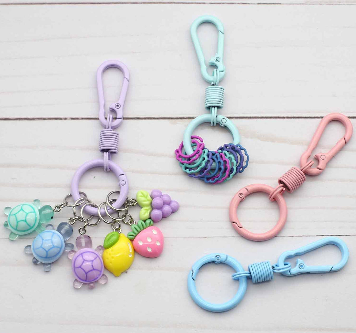 Colorful keychains with stitch markers on a wooden surface